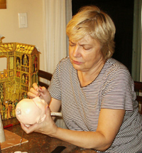 Marie building a puppet head out of paper clay